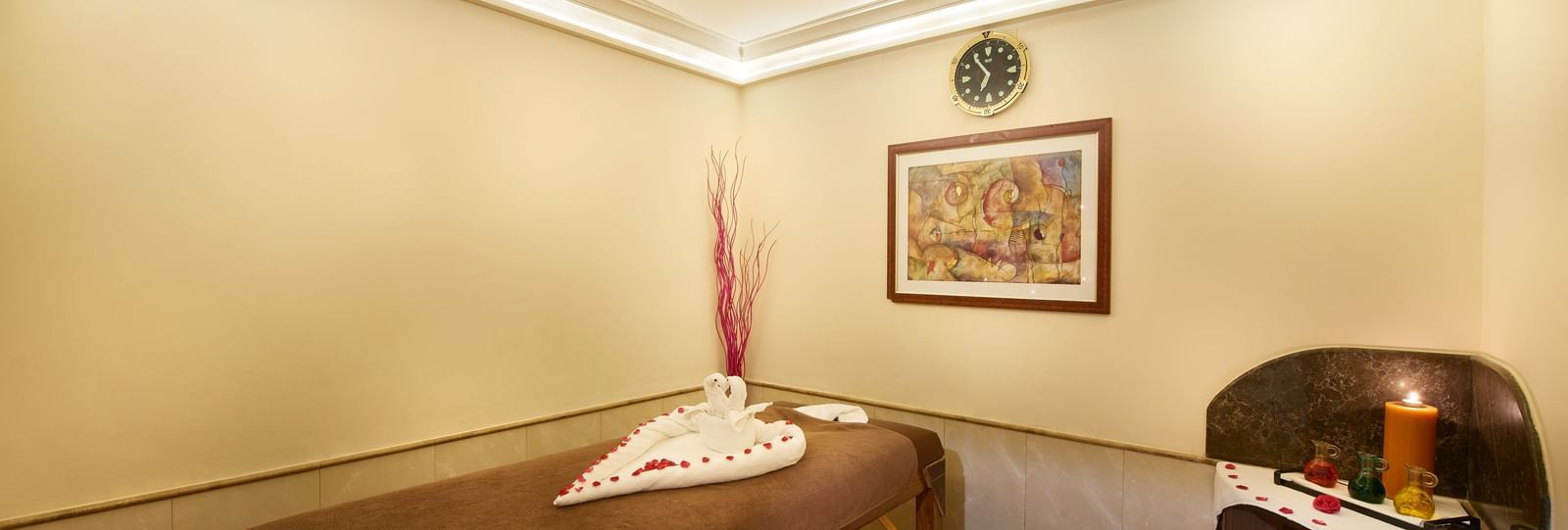 An image of a room with a massage bed and a cabinet tool where spa products are kept at Accord Hotels and Resorts, one of the best 5 star luxury spa hotels in Chennai.